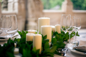 Chapel candle and floral arrangement table centrepiece